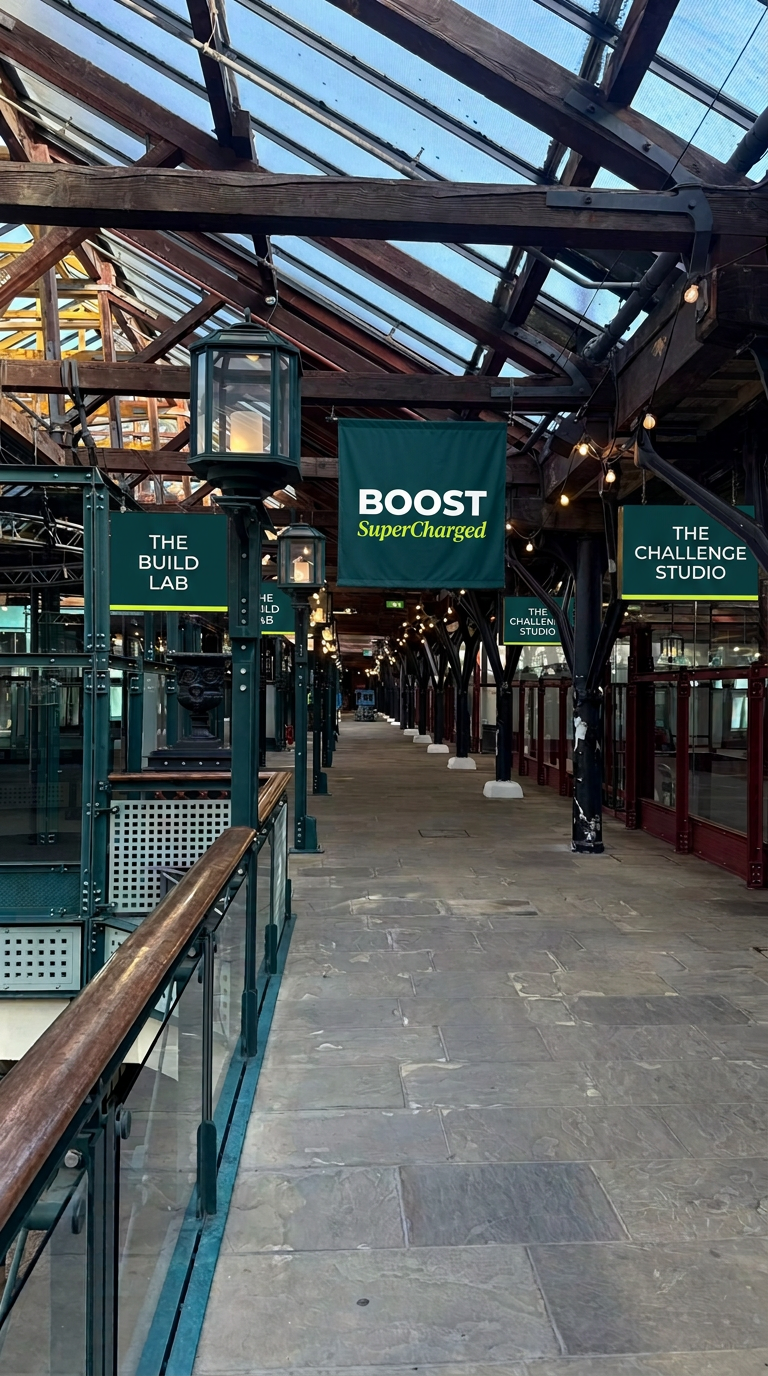 Walkway with signs for The build lab and The challenge studio and a BOOST SuperCharged banner
